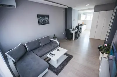 a living room with a couch and a table at King Exclusive Suites in Niš