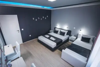 a bedroom with two beds and a room with at King Exclusive Suites in Niš