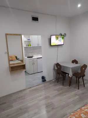 a kitchen and dining room with a table and chairs at Pavicevic in Soko Banja