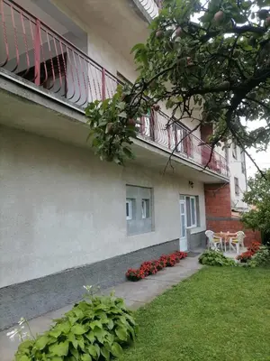 a building with a balcony and a table and flowers at Pavicevic in Soko Banja