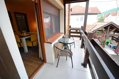 a small balcony with a table and chairs on it at Vila Almax in Soko Banja