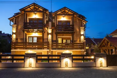 a building with lights in front of it at night at Vila Almax in Soko Banja
