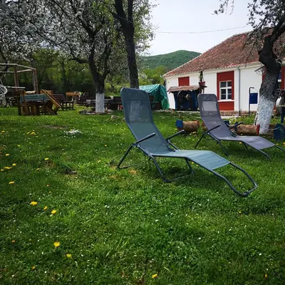 two chairs sitting in the grass in a yard at Etno Konak Angela in Kalna