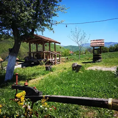 a gazebo in the middle of a grass field at Etno Konak Angela in Kalna