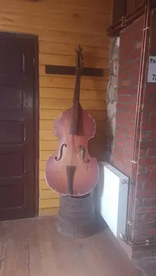 a large violin sitting on top of a brick wall at Etno Konak Angela in Kalna