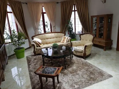 a living room with two chairs and a coffee table at Knez Apartmani in Senje
