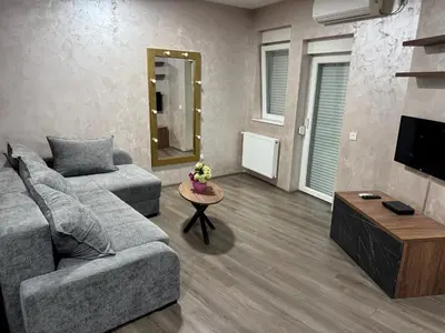 a living room with a couch and a table at La Apartamento in Jagodina