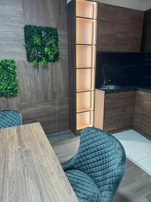 a dining room with a table and two chairs at La Apartamento in Jagodina