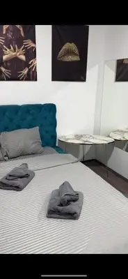 two towels are sitting on a bed in a room at La Apartamento in Jagodina
