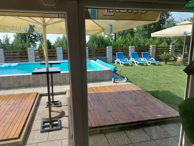 a view of a pool from a patio with an umbrella at Vila Boba Bor in Zlot