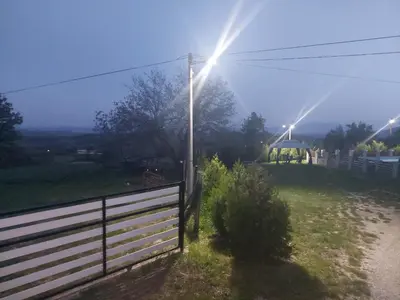 a field with a fence and a street light at Vila Boba Bor in Zlot