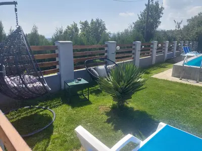 a backyard with a hammock and a fence at Vila Boba Bor in Zlot