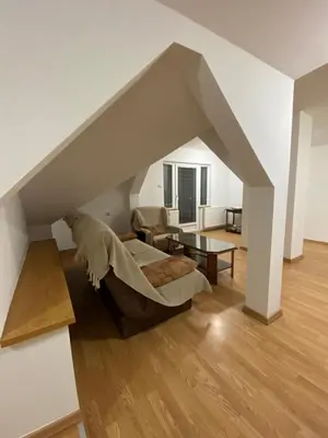 a living room with a couch and a table at Apartmani Djokić sa bazenom in Soko Banja