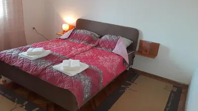 a bedroom with a bed with two boxes on it at Apartman Lela in Vranje