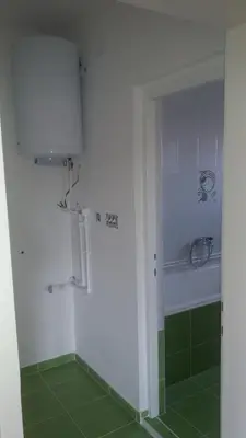 a bathroom with a shower with green tiles at Apartman Lela in Vranje