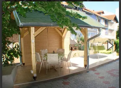 a gazebo with a table and chairs on a patio at Apartman Luka in Soko Banja