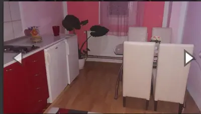 a kitchen with a white counter and a white chair at Apartman Luka in Soko Banja
