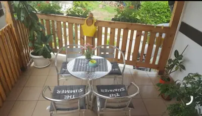 a patio with a table and chairs on a balcony at Apartman Luka in Soko Banja