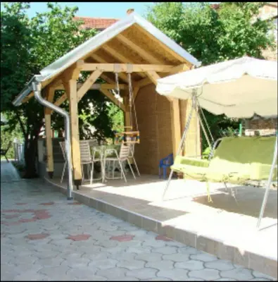 a patio with an umbrella and a table and chairs at Apartman Luka in Soko Banja