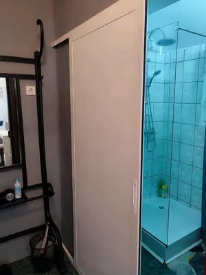 a shower with a glass door in a bathroom at Kum Apartment in Niš