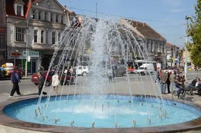 a fountain in the middle of a city at Tanja apartman in Jagodina