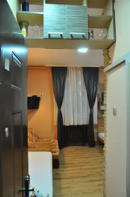 a small room with a bed and a window at Eco Kop in Kopaonik