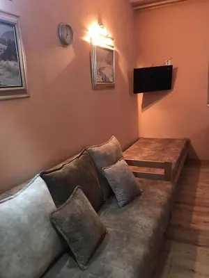 a living room with a couch with a television on the wall at Eco Kop in Kopaonik