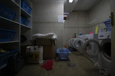 a laundry room with a washing machine and a washer at Hostel Teresianum in Aleksinac