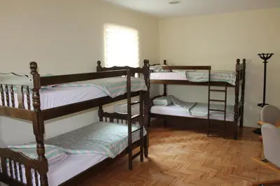 a room with four bunk beds with a window at Hostel Teresianum in Aleksinac