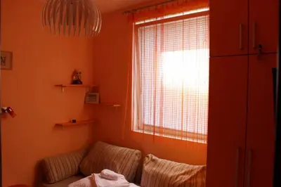 a living room with a couch and a window at Lila Apartman u Kraljevim Čardacima in Kopaonik