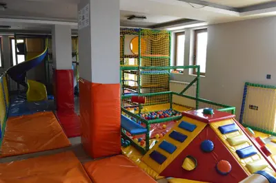 a childrens play room with a slide and a playground at Milmari Resort - Apartman L43 in Kopaonik