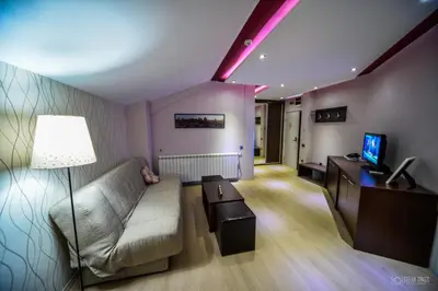 a living room with a couch and a tv at Garni Hotel 018 In in Niš