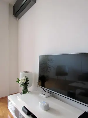a living room with a large flat screen tv at River View Nis - 65 square meters Designer Apartment in heart of city Park for free in Niš