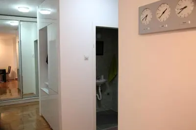 a bathroom with a glass shower and a sink at River View Nis - 65 square meters Designer Apartment in heart of city Park for free in Niš