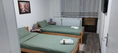 a small room with two beds and a window at Apartman Aleksic in Jagodina