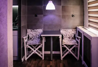 a purple kitchen with a table and two stools at Vladana DELUXE App 2 in Kruševac
