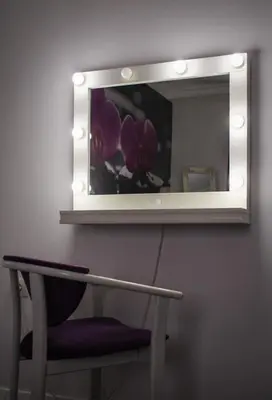a mirror on a wall with a chair under it at Vladana DELUXE App 2 in Kruševac
