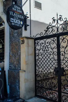 a gate to a building with a sign on it at Vladana DELUXE App 2 in Kruševac