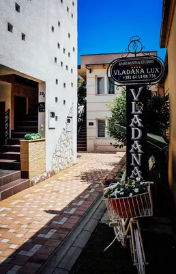 a bike with a basket parked in front of a building at Vladana DELUXE App 2 in Kruševac