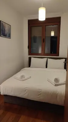 a bedroom with a large bed with two towels on it at Apartman Nensy in Vrnjačka Banja