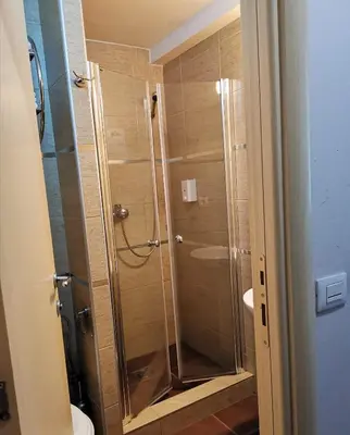 a shower with a glass door in a bathroom at Apartman Masa Kopaonik in Kopaonik