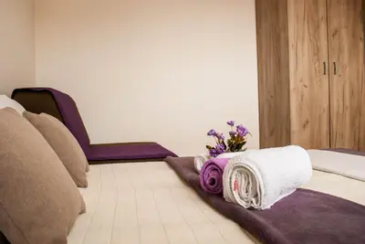 a room with a bed with towels and flowers on it at Apartman Soko in Soko Banja
