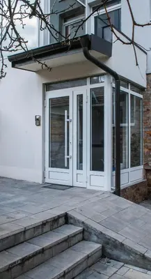 a white door with glass panels on a building at Apartman Soko in Soko Banja