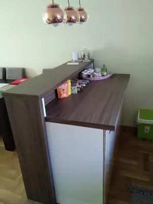 a wooden desk in a room with a counter at apartman Vita in Vrnjačka Banja