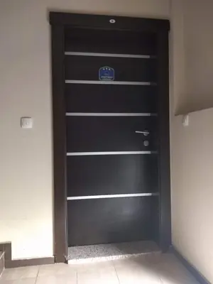 a black garage door with a sign on it at apartman Vita in Vrnjačka Banja