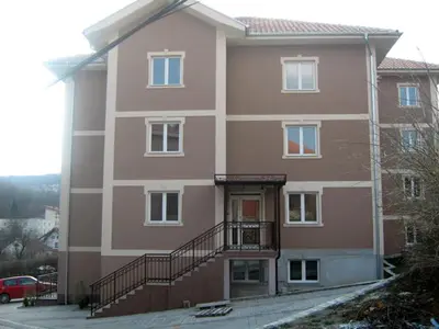 a large building with a staircase in front of it at apartman Vita in Vrnjačka Banja