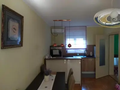 a kitchen with a counter and a table in it at apartman Vita in Vrnjačka Banja