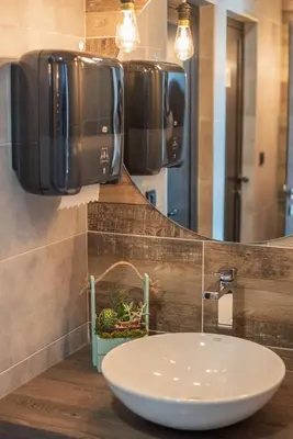 a bathroom with a sink and a mirror at Hotel Aloha in Niš