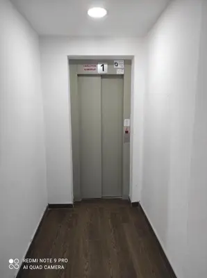 an empty hallway with a elevator in a building at Kopaonik Milmari apartman L33 in Kopaonik