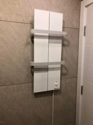 a white shelf on a wall with two white boxes at Kopaonik Milmari apartman L33 in Kopaonik